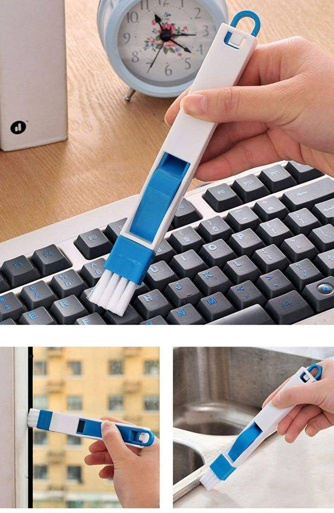 Keyboard cleaning brush with blue bristles being used on a keyboard, window, and surface.