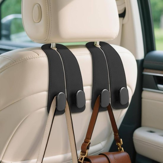 Car seat headrest hook holding a brown leather handbag in a vehicle interior.