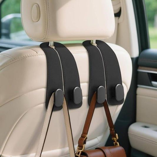 Car seat headrest hook holding a brown leather handbag in a vehicle interior.