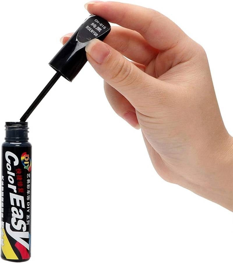 Hand holding a black eyeliner pen with 'ColorEasy' branding against a white background