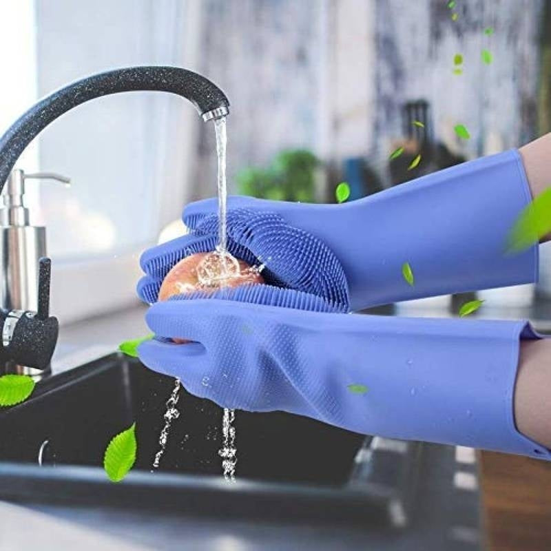 Person wearing blue gloves washing an apple under running water in a kitchen sink.