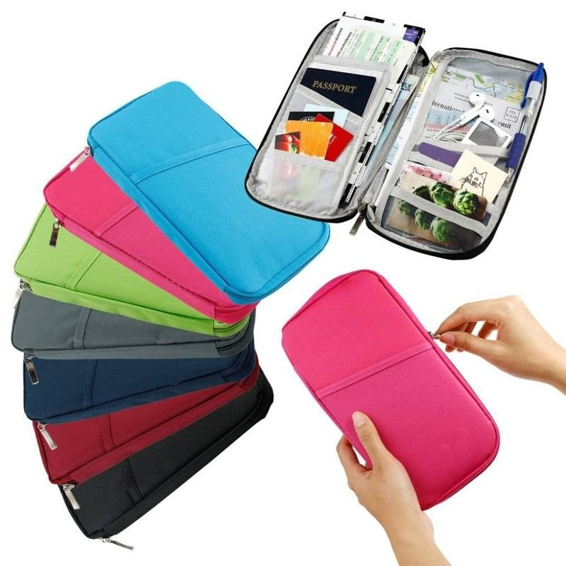 Colorful travel organizer with compartments and a hand holding a pink one.