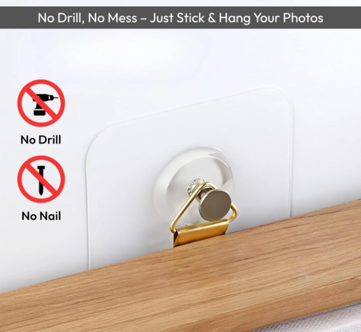 Wall-mounted photo holder with gold clip on a white wall, featuring 'No Drill' and 'No Nail' icons.