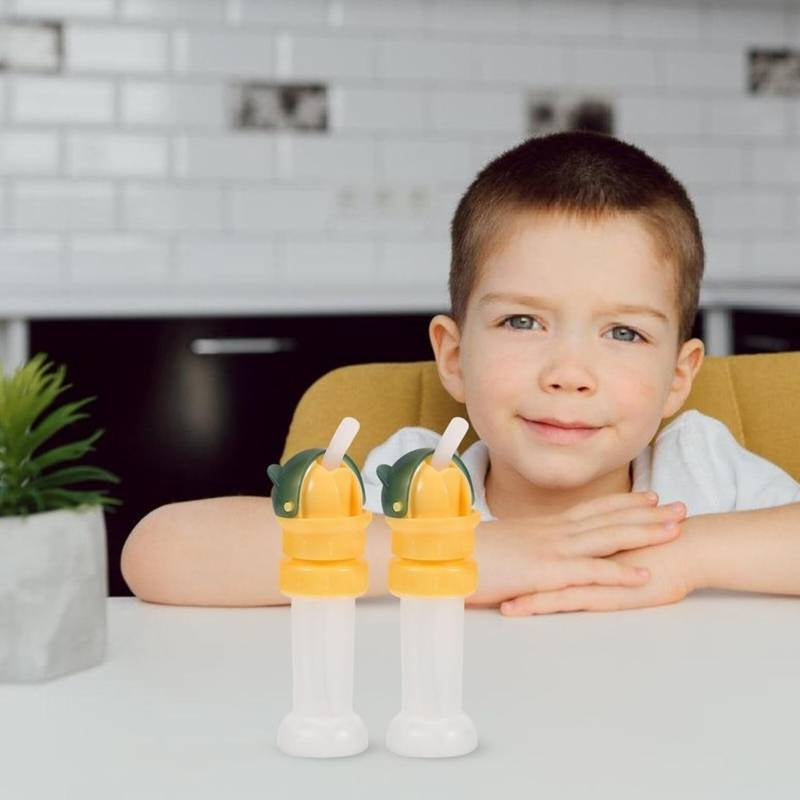 Child with two popsicles on a table in a kitchen setting