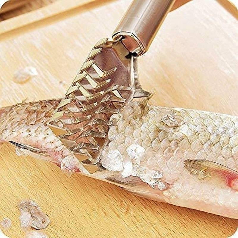 Fish scaler being used to remove scales from a fish on a wooden cutting board.