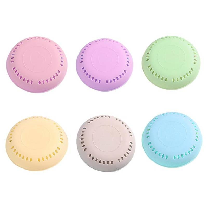 Set of six pastel-colored laundry detergent pods on a white background