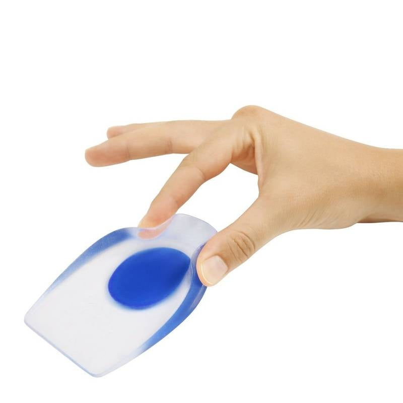 Hand holding a small blue and white device on a white background