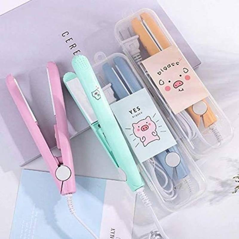 Set of small hair straighteners with cute designs in a clear case on a light background