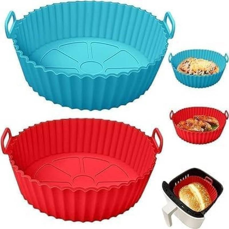 Two silicone baking pans, one blue and one red, with handles, used for cooking and baking.