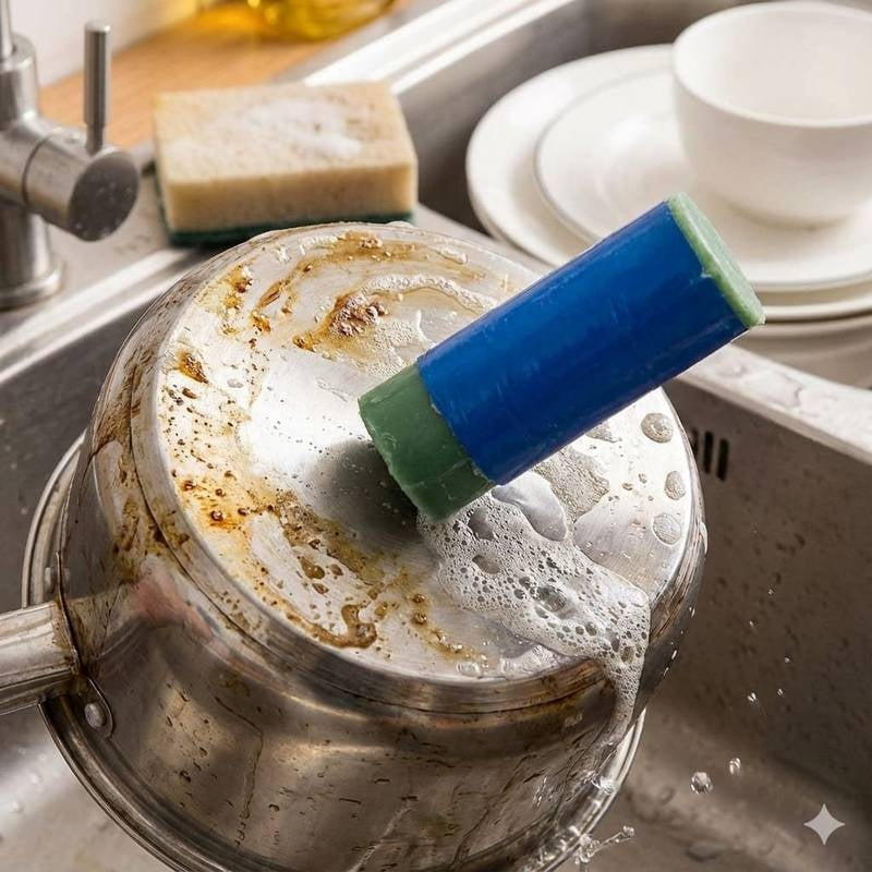 Cleaning brush scrubbing a rusty pot in a kitchen sink.