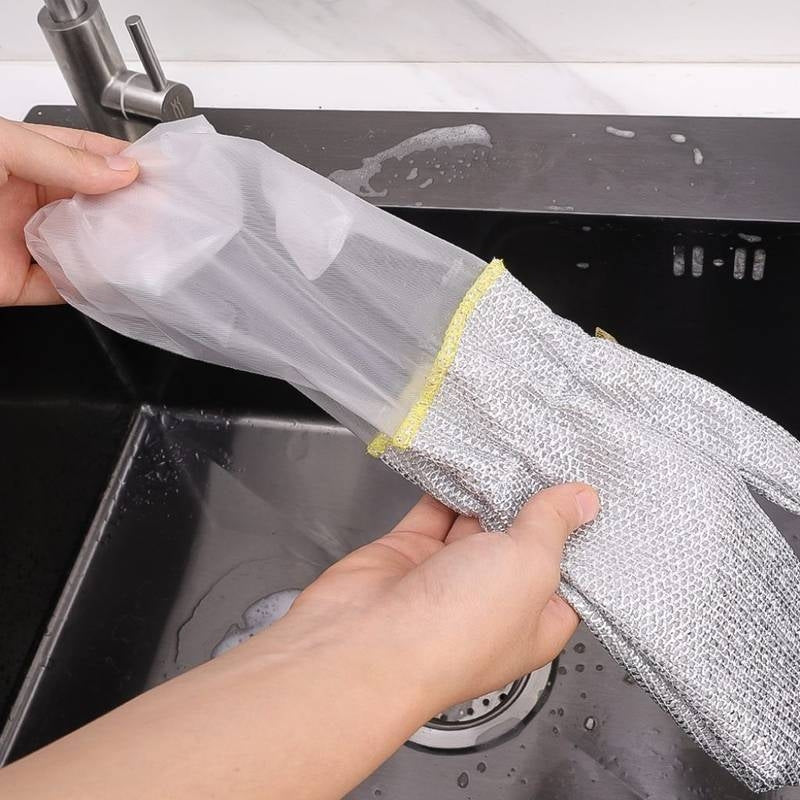Person holding a metallic scrubbing glove over a sink