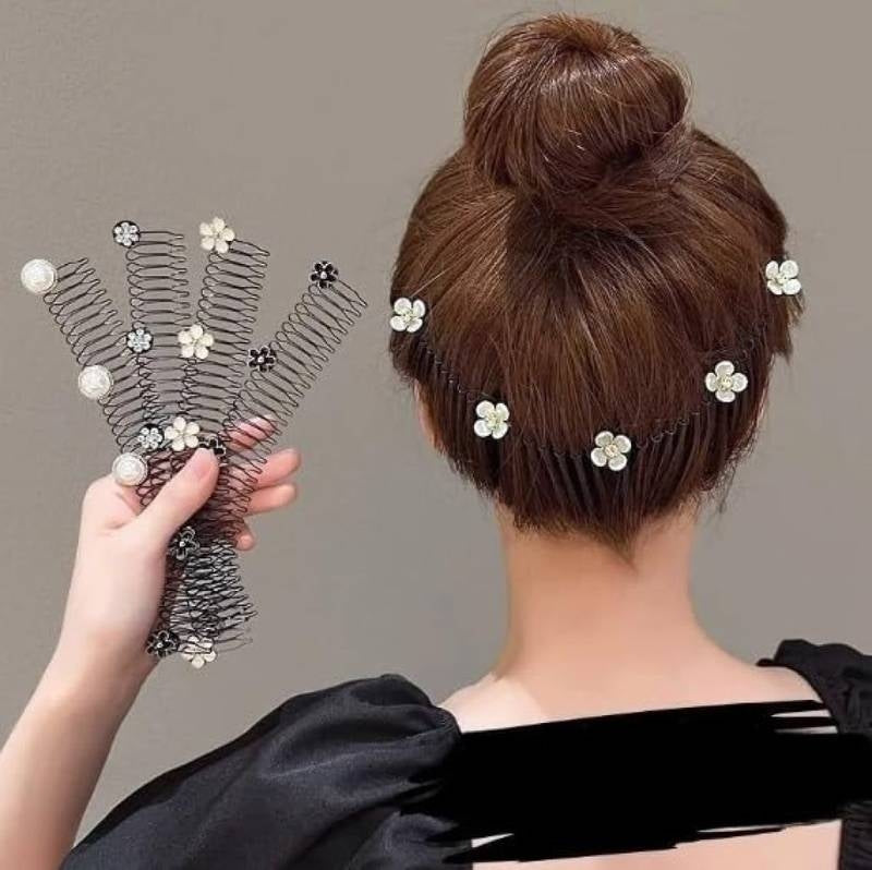 Hair accessories with flowers and pearls held by a hand, displayed against a neutral background.