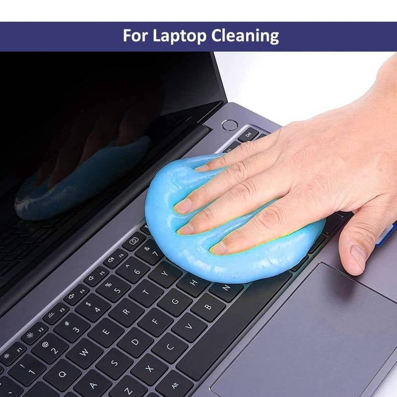 Person using a blue cleaning tool on a laptop keyboard