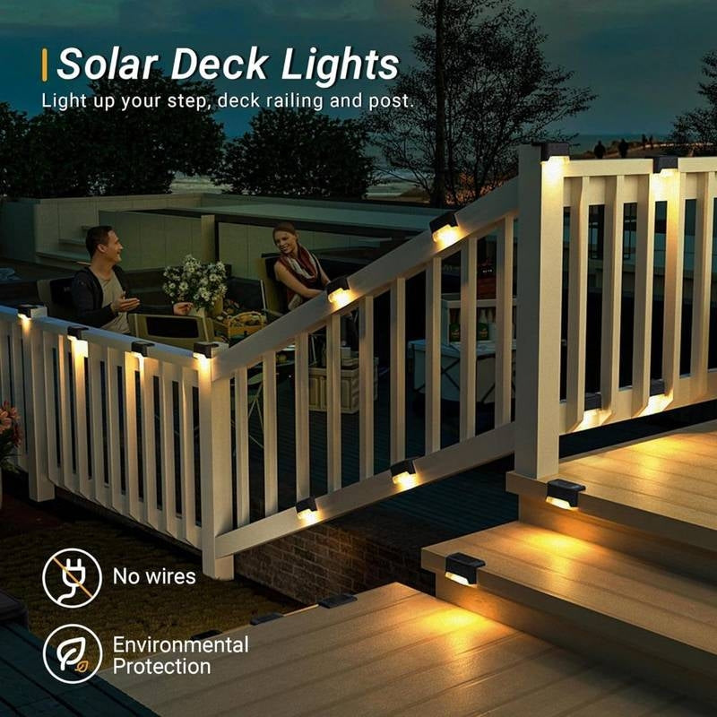 Solar deck lights illuminating a wooden deck with people sitting at a table.
