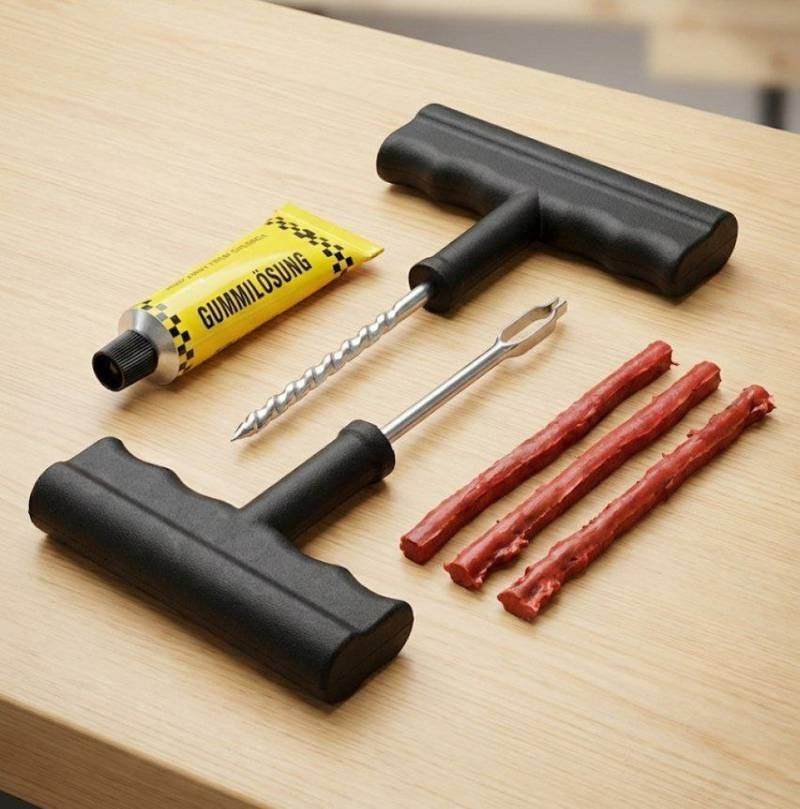 Black tools and red sticks on a wooden surface