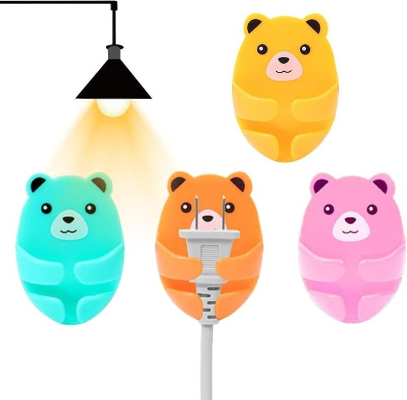 Four colorful bear-shaped night lights on a white background