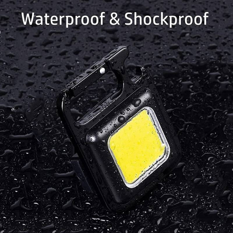 Black waterproof and shockproof device with a yellow light on a black textured background