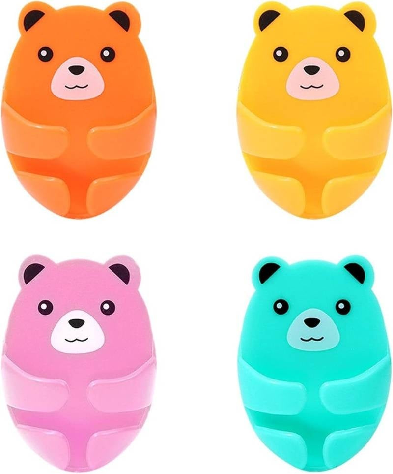 Four colorful bear-shaped objects in orange, yellow, pink, and blue.