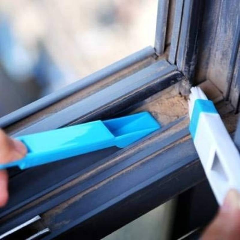 Person using a blue tool to clean a window frame