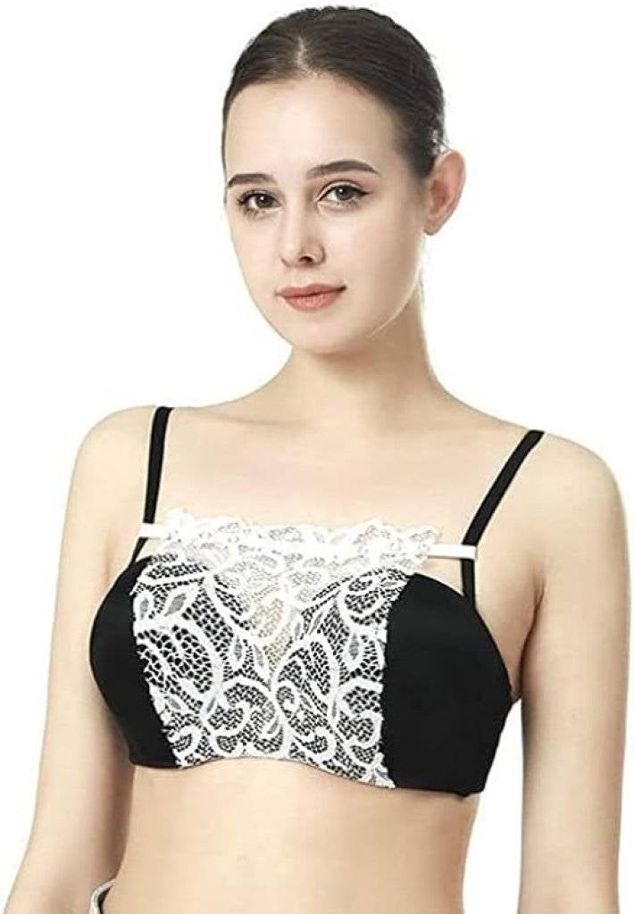 Woman wearing a black and white lace bralette against a white background