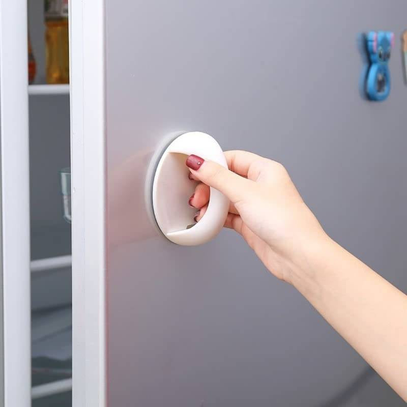 Hand using a white doorknob on a gray door