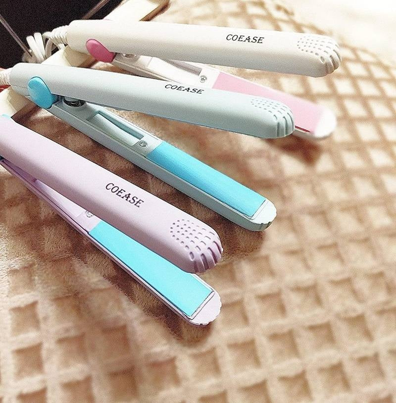 Set of COEASE hair straighteners in various colors on a textured surface
