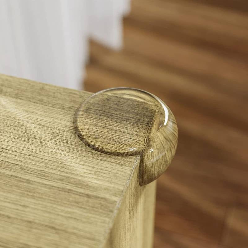 Close-up of a wooden chair arm with a clear liquid droplet on a blurred background