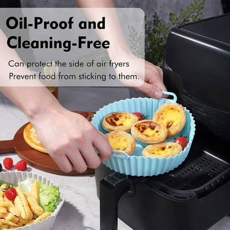 Person placing a silicone baking dish with pastries into an air fryer, with text highlighting features.